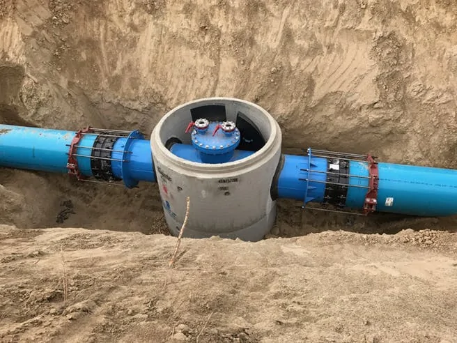 Air release valve chamber piping in a manhole