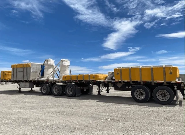 Combined equipment shipments loaded onto trucks for transport